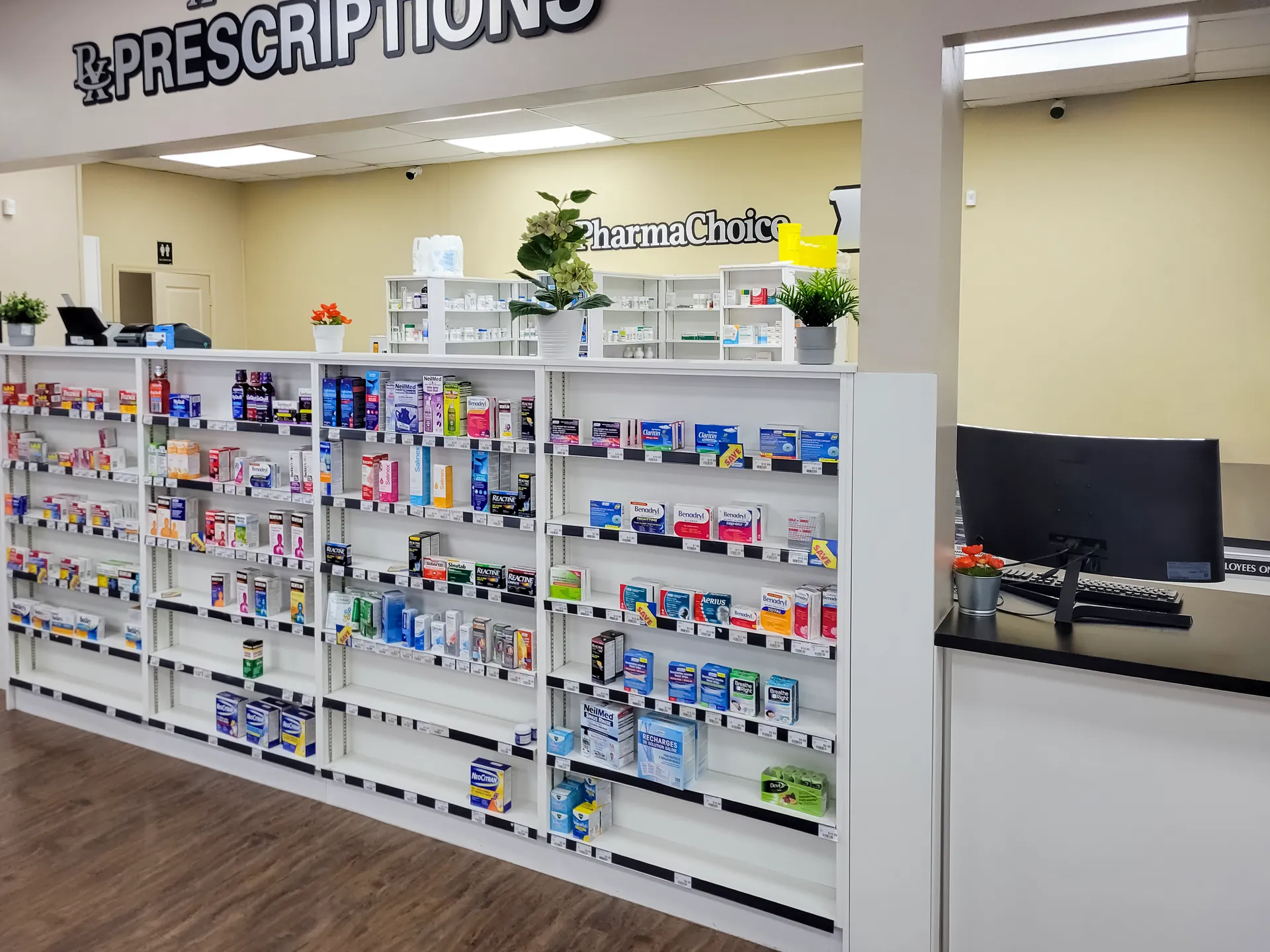 Finished pharmacy retail floor and prescription counter built by Central Alberta Cabinets